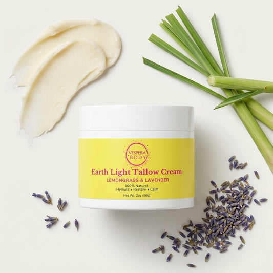 Earth Light Tallow Cream jar surrounded by lemongrass, lavender, and natural tallow ingredients, highlighting its clean, nutrient‑rich skincare formula.