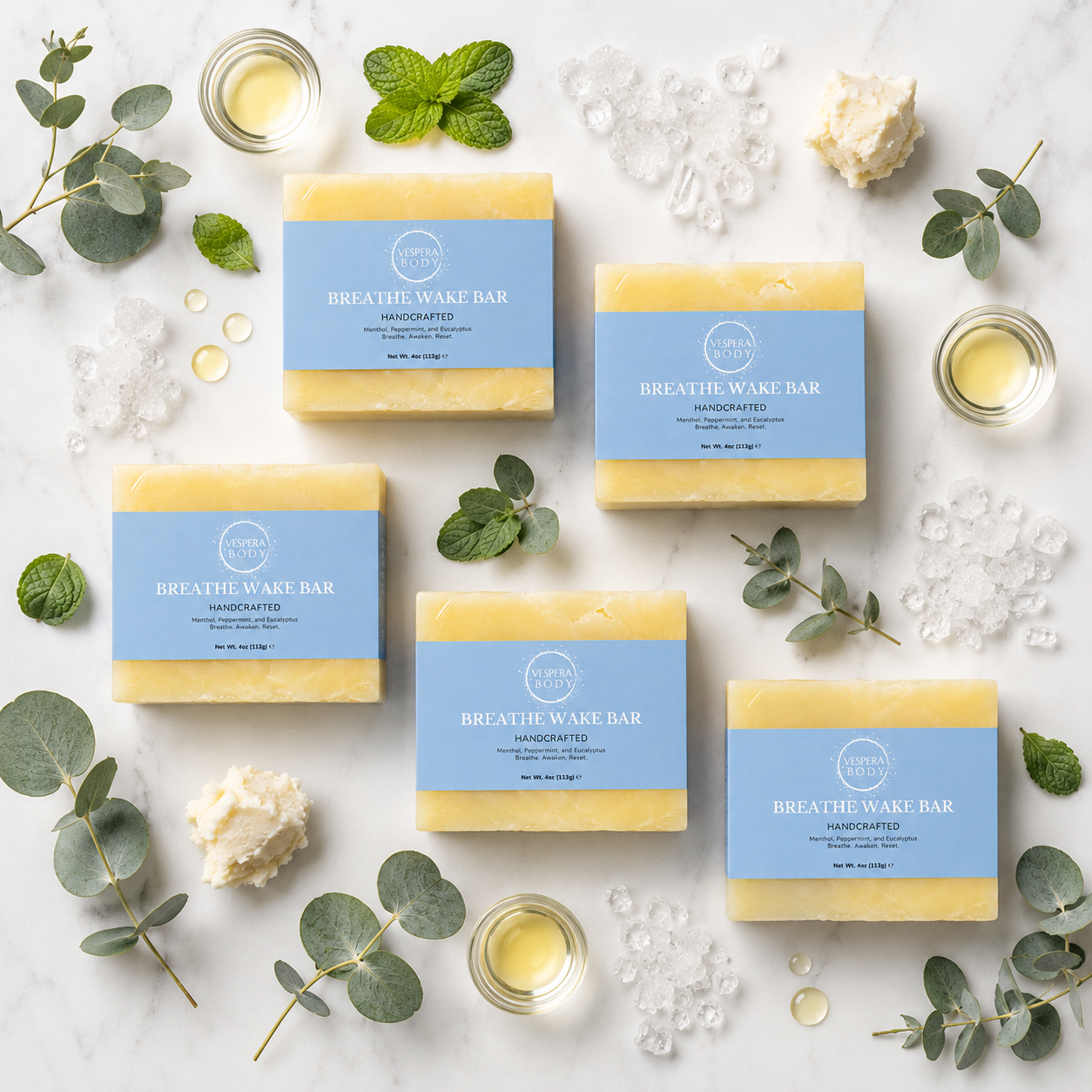 Vespera Body Breath Wake moisturizing soap bar ingredients flat lay with fresh eucalyptus leaves and menthol crystals.